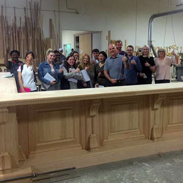 Class group photo behind a wraparound bar