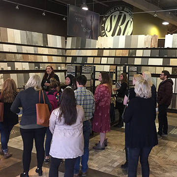 Students hearing a lecture at an interior design materials store