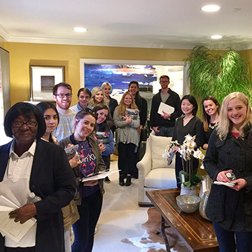 Students posing in a living area in a showroom