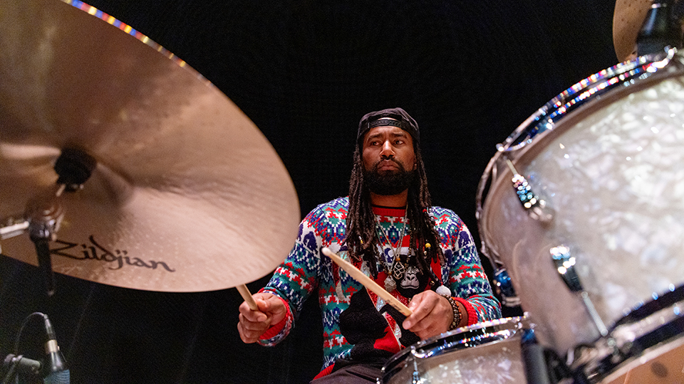 Close-up of student playing drums in the Jazz Band