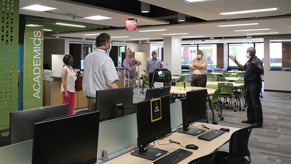 A small group of JCCC staff and trustees tours the new Academic Resource Center.