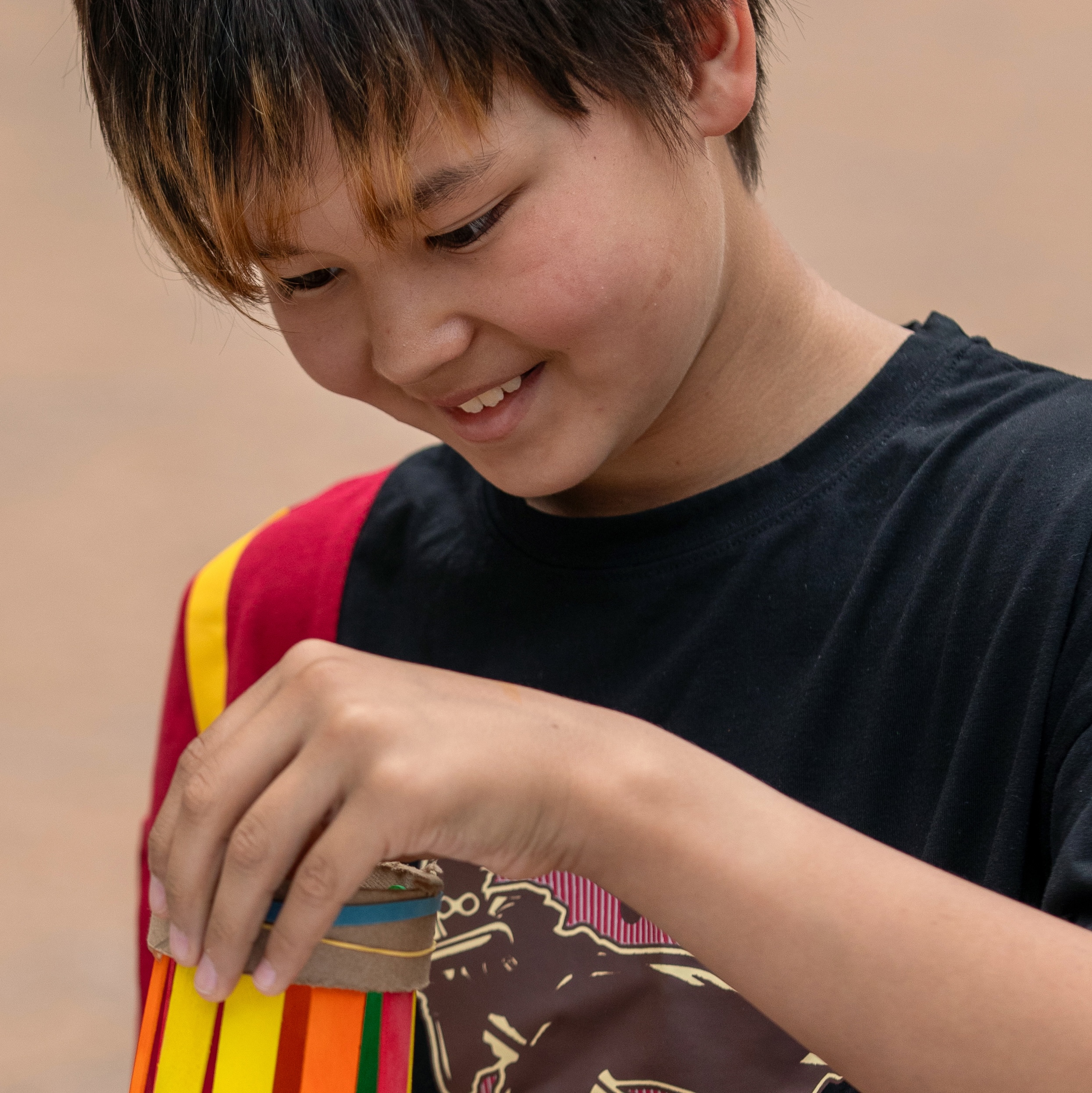 A young boy holds a handmade kite.