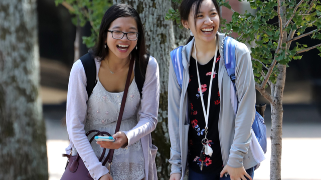 Two students walking on campus on the first day of classes.