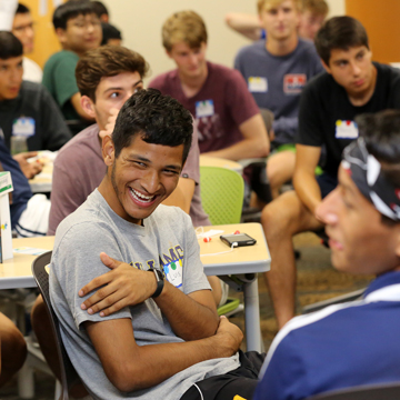 A student in a class laughs during a class discussion.