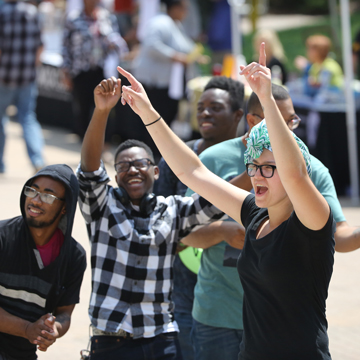 A group of students cheer and dance during the fall Cavalier Kickoff event.