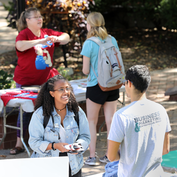 A student talks with a representative of the Business Marketing and Entrepreneurship club.