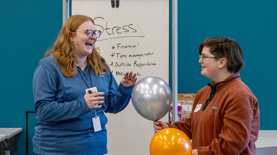 A student talks with a Success Coach during a Cav Connection event.