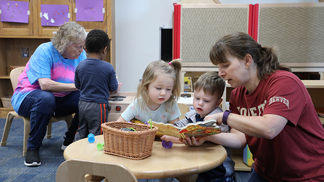 Two HCDC aides working with young children