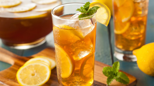 A glass of iced tea garnished with a lemon slice