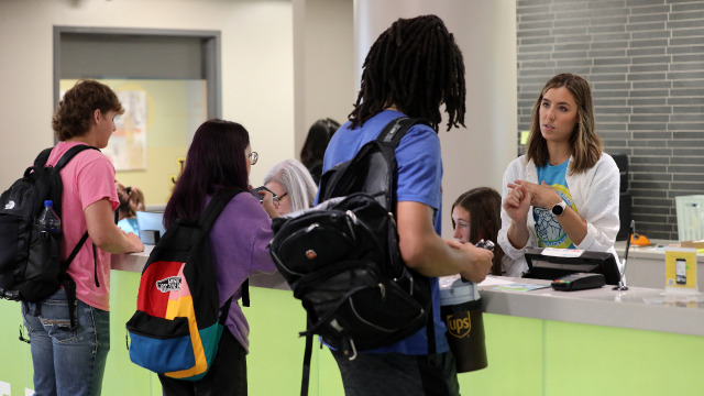 Students speaking to helpful people at the Student Engagement Desk