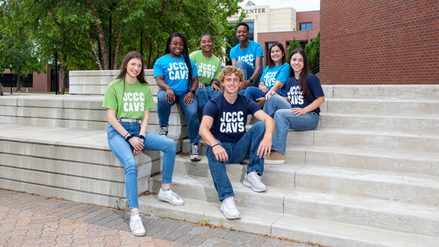 Student ambassadors sitting on the steps in the COM courtyard