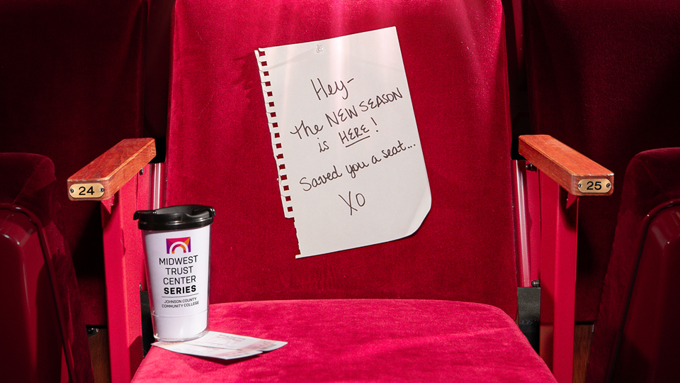 a velvet theatre chair in Yardley Hall with a note on it that reads Hey - the new season is here! Saved you a seat... xo