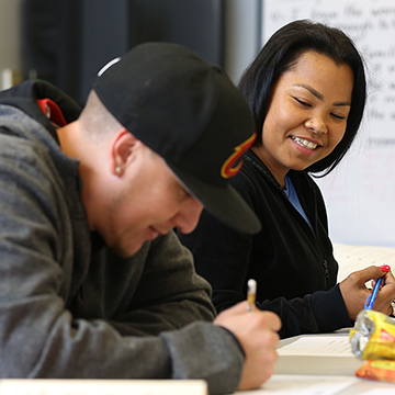 Two students enjoy a JCAE class that is helping them prepare to take the GED®.