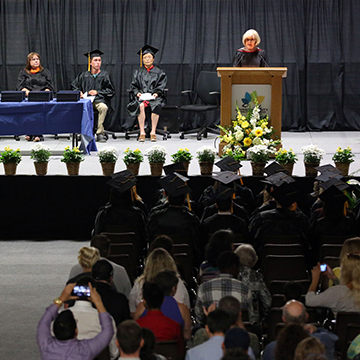 Speaker and crowd at GED graduation ceremony.