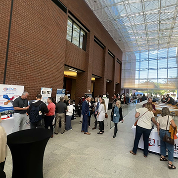 Attendees of the 2024 Healthcare Simulation conference visit vendor tables in the atrium