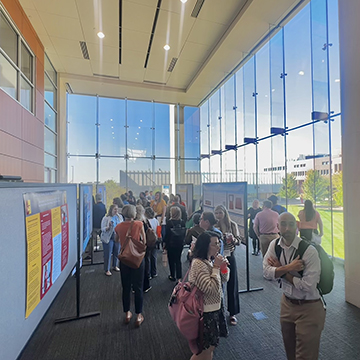 Attendees of the 2024 Healthcare Simulation conference review posters during the poster session