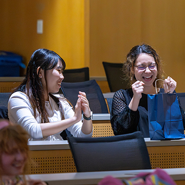 three students celebrating an announcement at the Japanese shorts festival