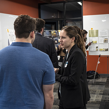 Faculty check out presentations at the symposium.