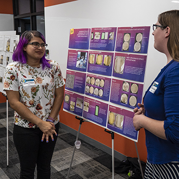 Student explains her findings during the symposium.