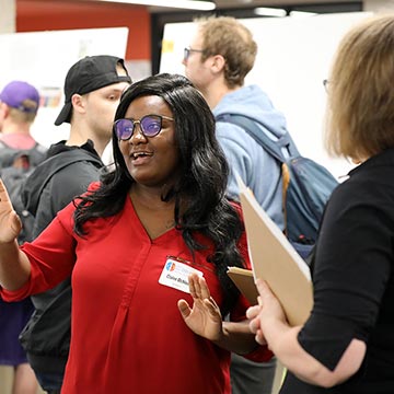 Student defend their work to faculty presented during the symposium.