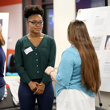 Students discuss the work presented during the symposium.