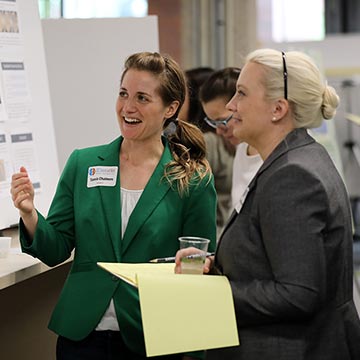 Faculty admire the presentations during the symposium.
