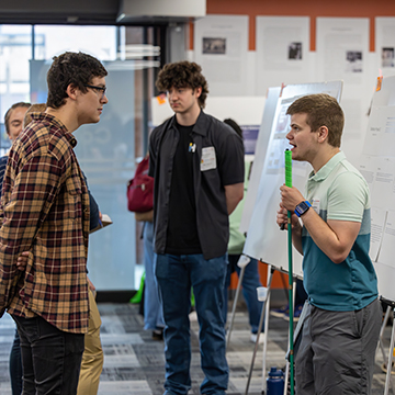 jccc students discussing a poster at the STEM Poster Symposium
