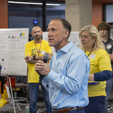 JCCC president Dr. Tony Miksa speaks to a crowd of Symposium attendees