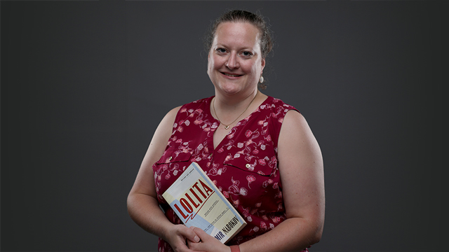 Eve Blobaum holding a copy of the book "Lolita"