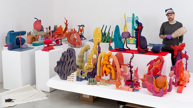 Matthew Ronay with an array of his colorful art in his studio.
