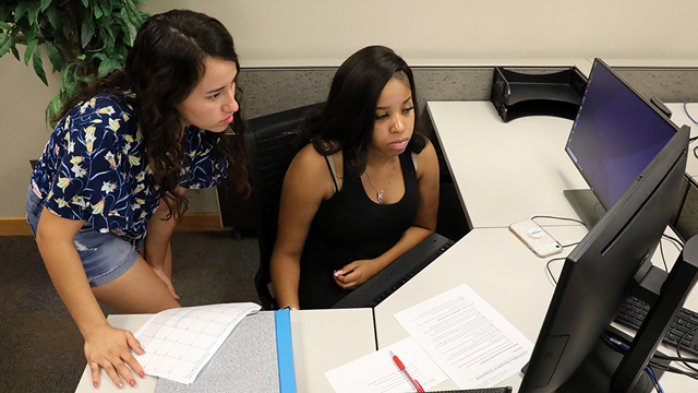 Two students working together at a computer