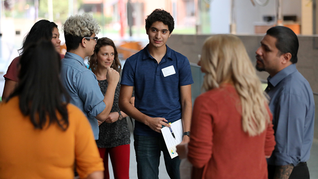 A group of students talk with a tour guide at JCCC.