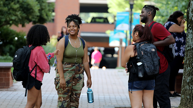 A group of students visit on the JCCC campus.