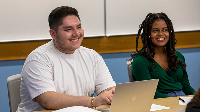 Two students working at laptops.