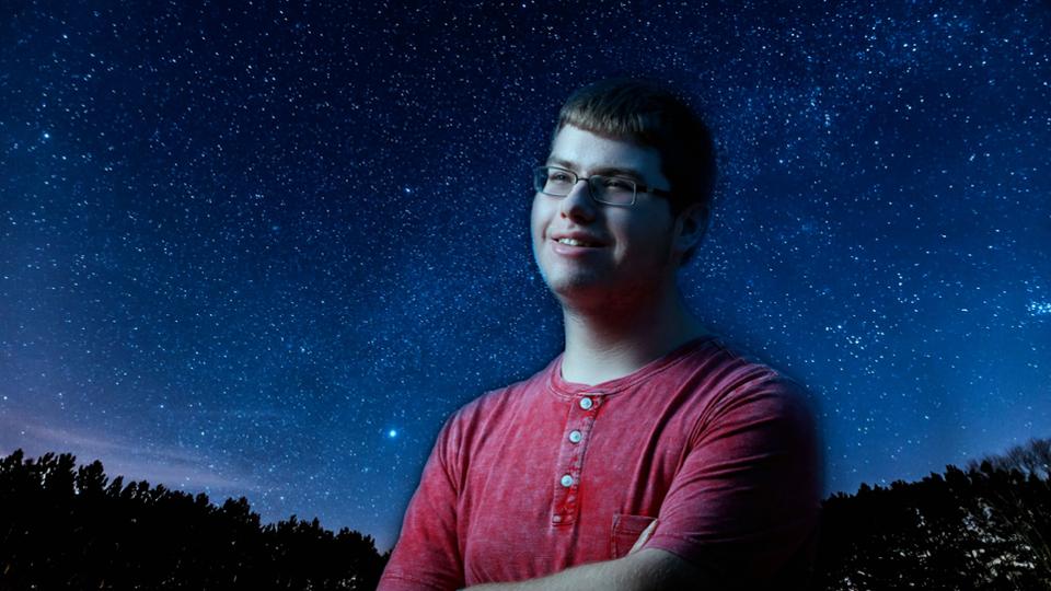 Image of Jack Conners standing against a starlit night sky