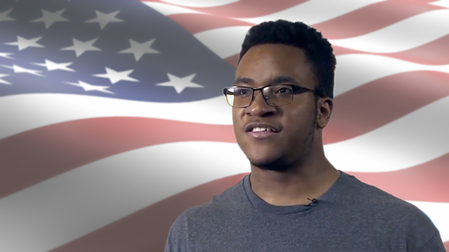 JCCC student looking into the distance against a backdrop of the American flag