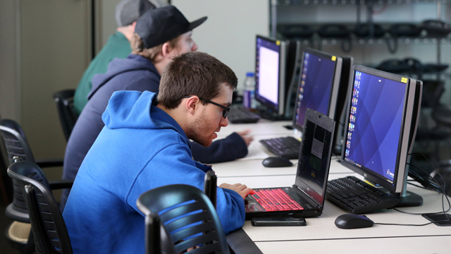 High school IT students working in a computer lab
