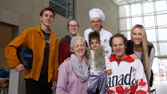 All adult members of the Schmidt family posing in the Shull Foyer of the Nerman Museum of Contemporary Art