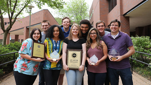 Members of the JCCC debate team pose with their national trophies.