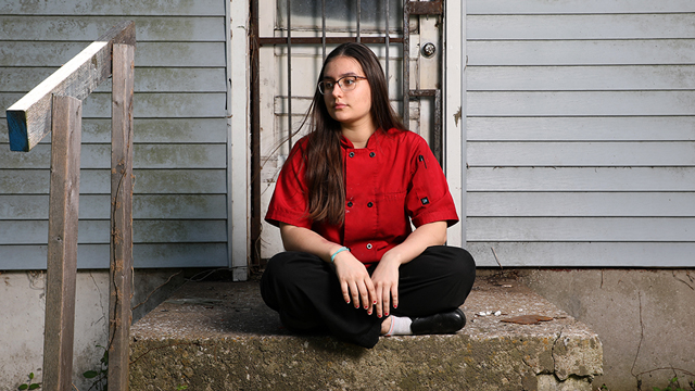 Isabelle Bohlken since cross-legged on the porch outside her home