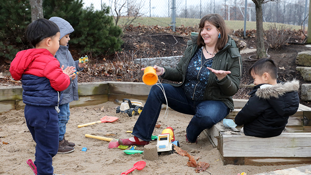 Jennie Brockhoff talks with her kids and plays in the sandbox with them during some time outside.