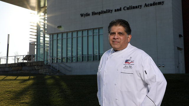 Jesse Vega standing outside the Wylie Hospitality and Culinary Academy