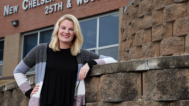 Megan Segraves poses in front of New Chelsea Elementary School at 25th and Wood in Kansas City, Kansas.