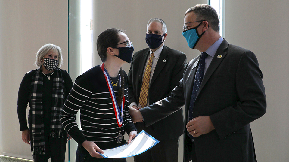 JCCC President Dr. Andy Bowne congratulating Jacqui White with JCCC Trustees Nancy Ingram and Lee Cross in attendance. 