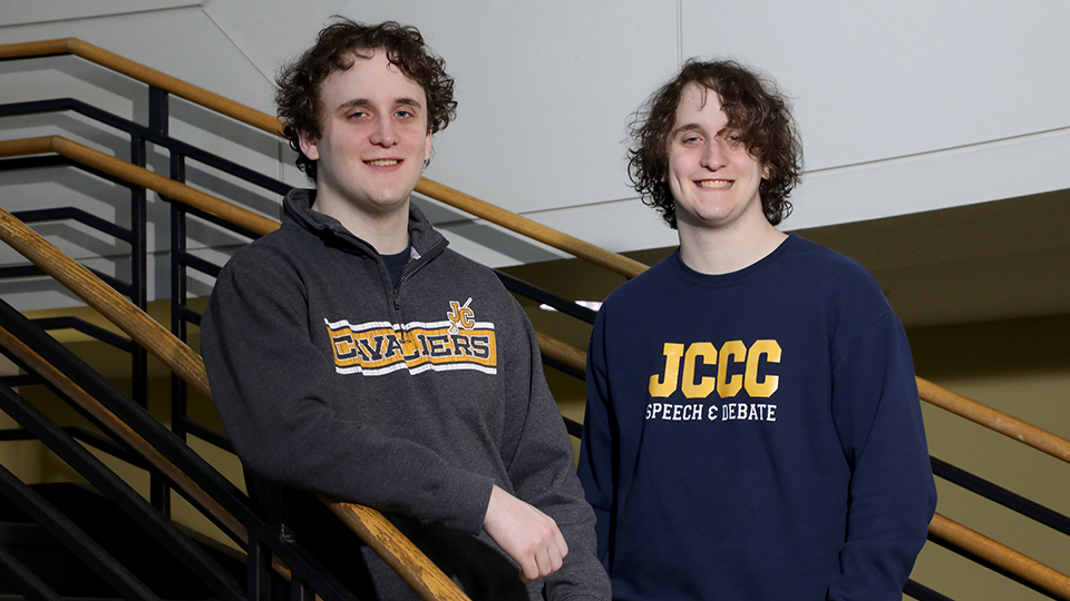 Brothers Travis (on the left) and Thomas (on the right) Babcock pose on stairs.