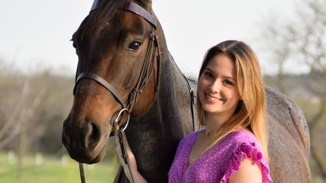 Abby Obertop standing with her horse
