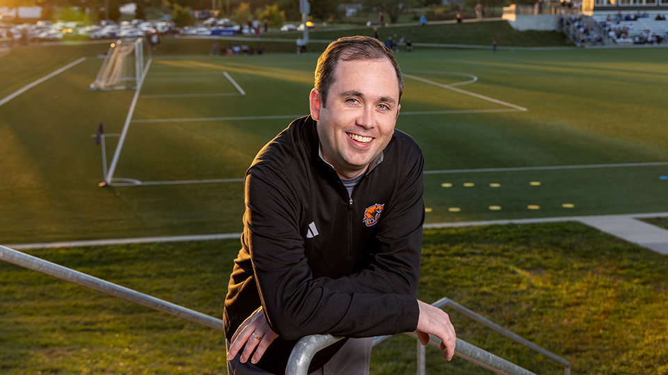Brandon Milburn with a soccer field in the background
