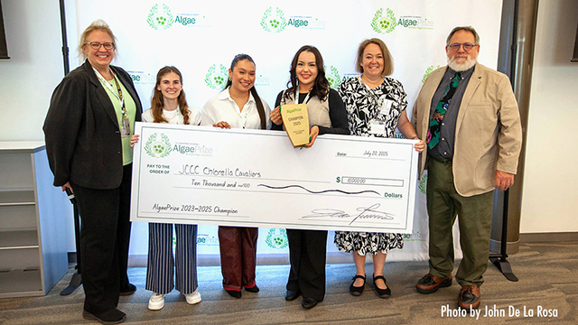 ChlorellaCavs team posing with a giant check representing their win
