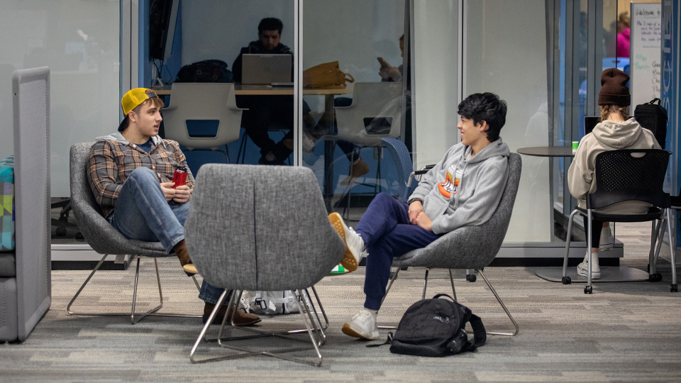 Students chatting in a study space lounge.