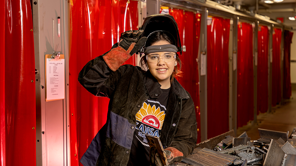 Jasmine Gambhir posing wearing her welding helmet and gloves